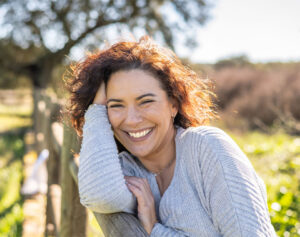 Happy Woman Smiling At Camera In A Field