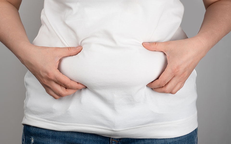 woman pinching belly fat