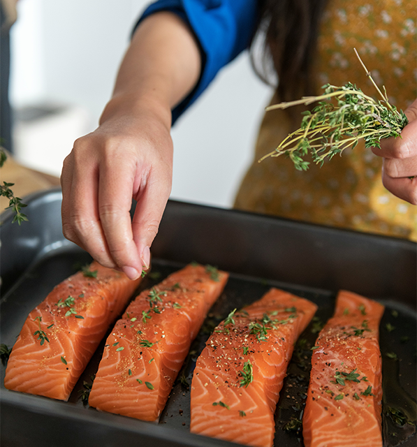 person cooking salmon